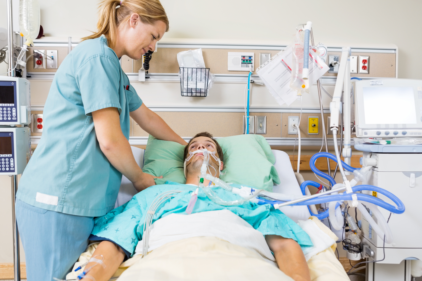 Nurse adjusting her patient's pillow