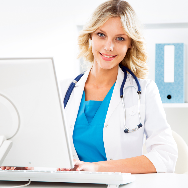 Nurse looking at camera with laptop