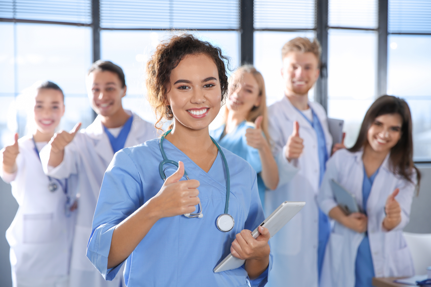 Two nurses giving a thumbs up